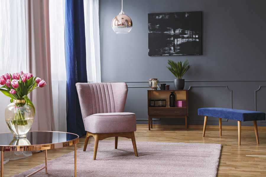 pink accent chair and blue bench in modern living room
