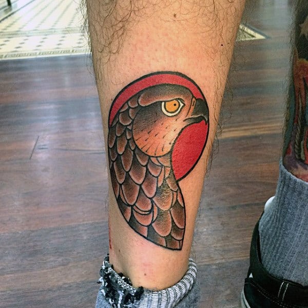 Stylized Hawk In Front Of Sun Tattoo On Male
