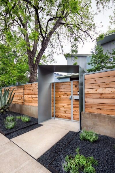 modern wood and metal front yard fence with elaborate gate 