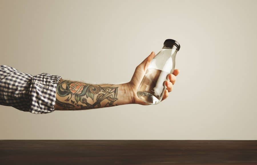 tattooed arm with water bottle