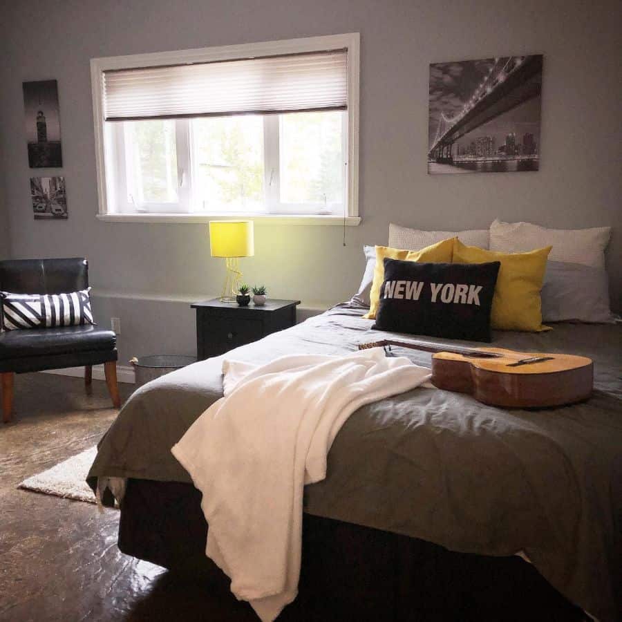 simple bedroom with guitar on bed