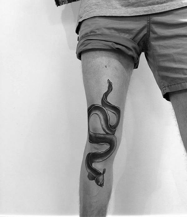 Thigh And Leg Eel Tattoo Design On Man