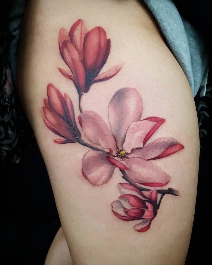 10. Magnolia Thigh Tattoos.