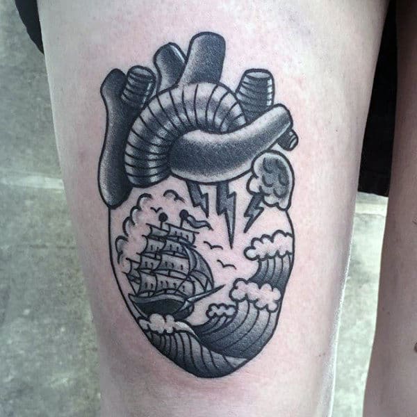 Thigh Tattoo Of Heart With Sailing Ship Male Traditional Tattoo Designs