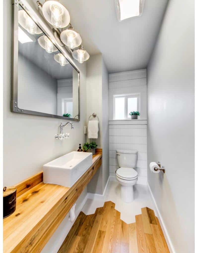 shiplap wall powder room wood vanity white sink large wall mirror 