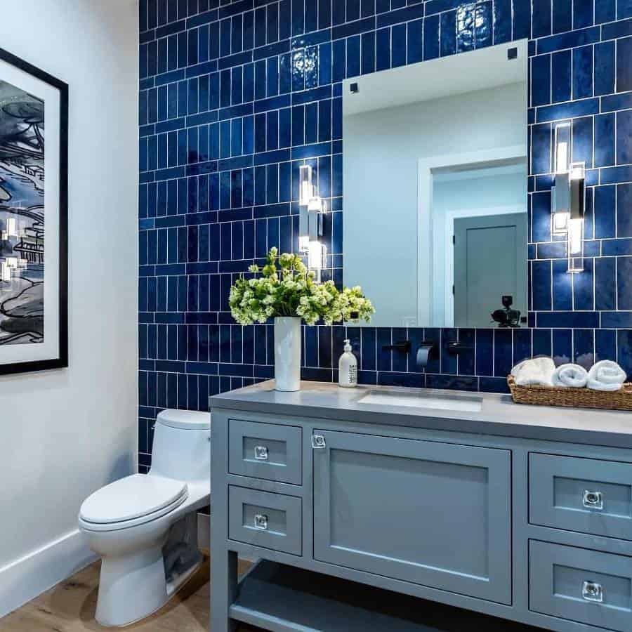 blue wall tile powder room blue cabinet vanity large wall mirror 
