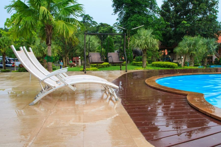 tile and wood patio pool deck with sun loungers