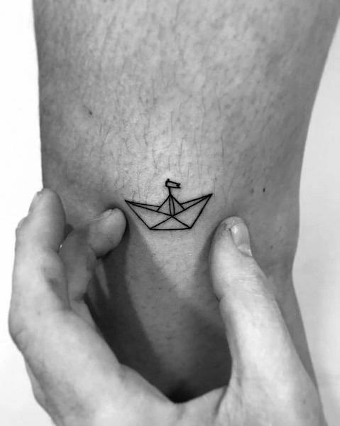 Small boat tattoo on the bicep - Tattoogrid.net