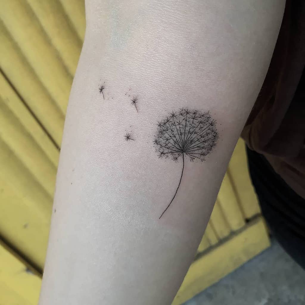 tiny fine line dandelion tattoo