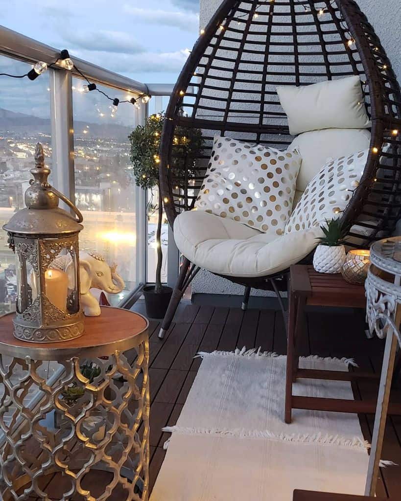 small wood deck balcony with egg chair and fairy lights 