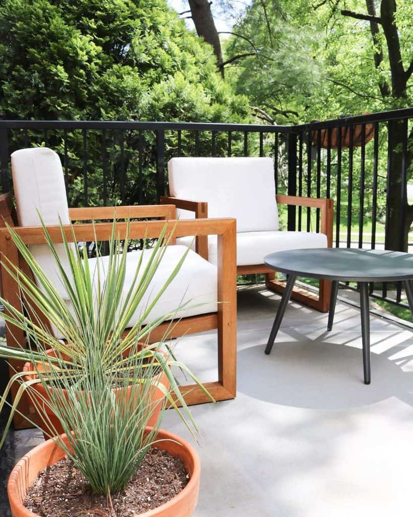 balcony apartment patio with wood chairs and table 