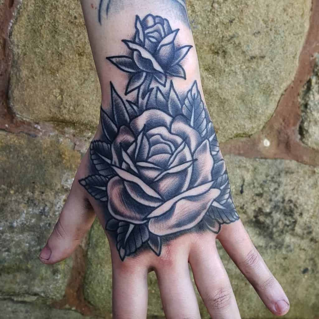rose tattoo black and white on hand