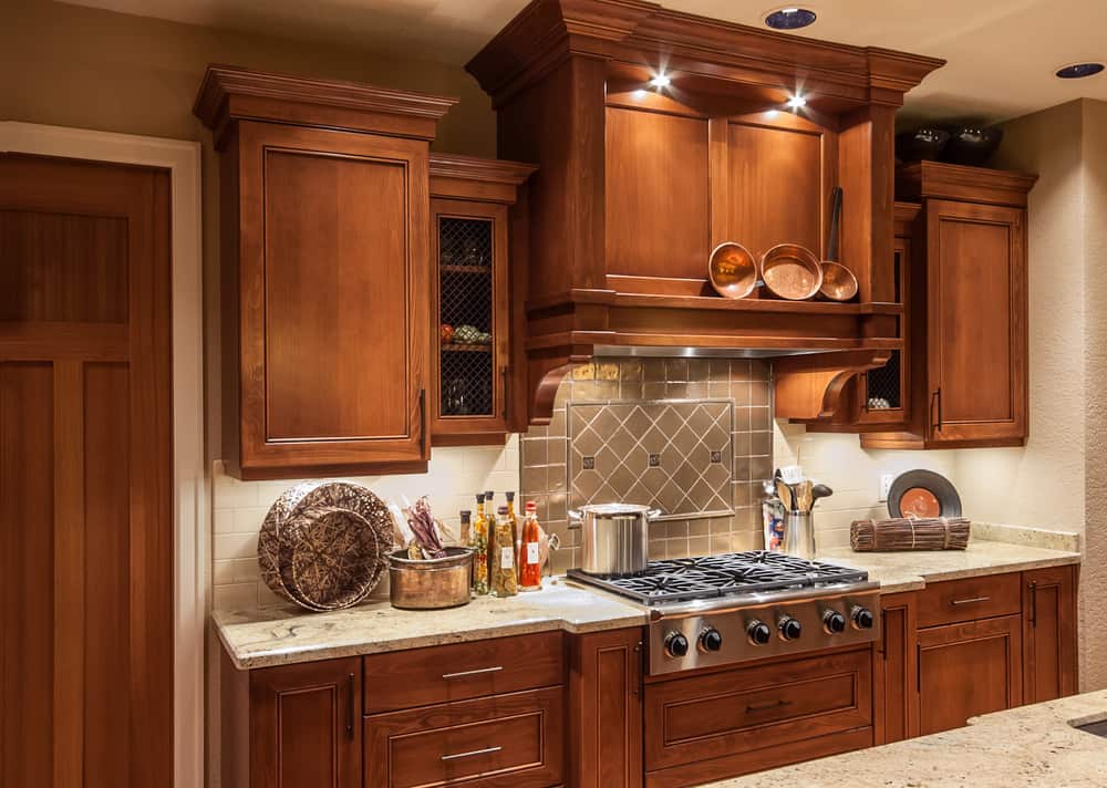 traditional farmhouse kitchen brown wood cabinets gray tile splashback 