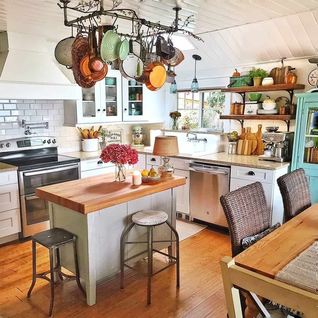 traditional rustic farmhouse kitchen hanging pots and pans wicker chairs hardwood floors