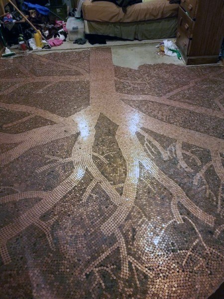 Penny tile floor featuring an intricate tree design with branching roots in a bedroom setting.