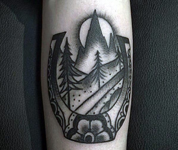 Trees With Mountain And Traditional Horseshoe Mens Forearm Tattoo