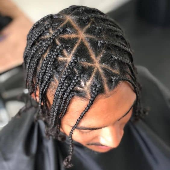 A twisted hairstyle for men created in two-strand with sections forming triangle. It is a modern take from box patterns