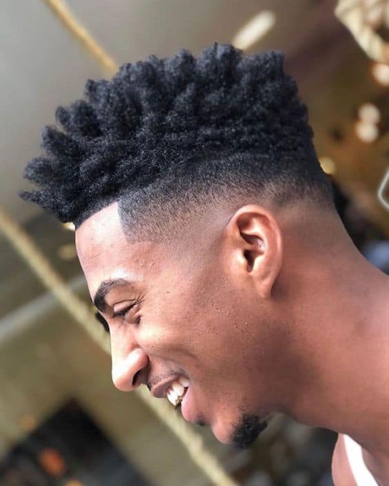A haircut featuring high top twists and a mid-length taper cut