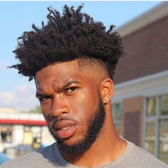 A haircut featuring top twists on top and paired with low taper fade for a unique look
