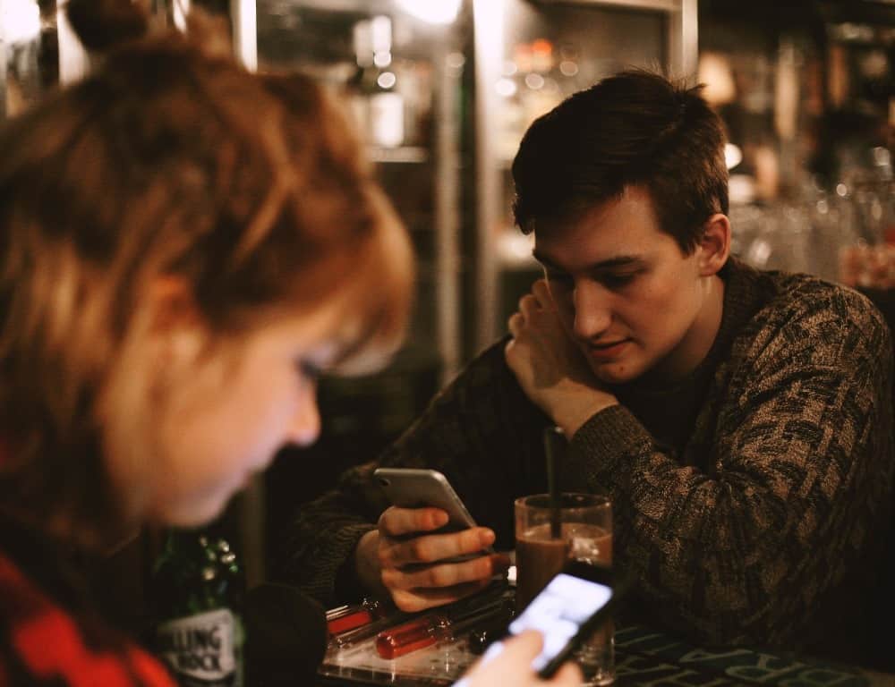 two people both looking at their phone