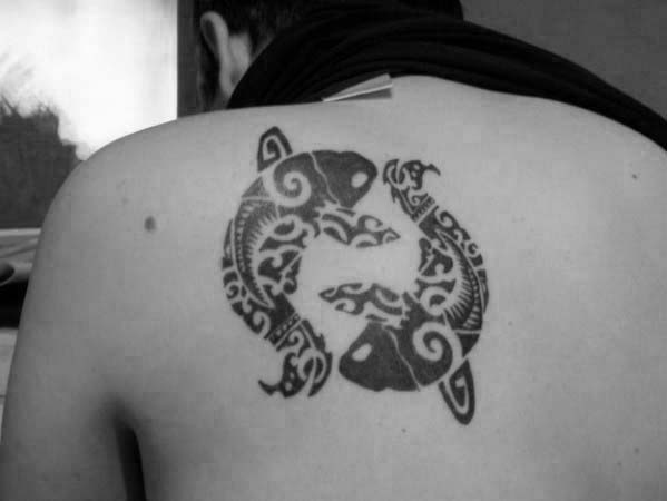 Two Swimming Tribal Fish Upper Back Tattoos For Males