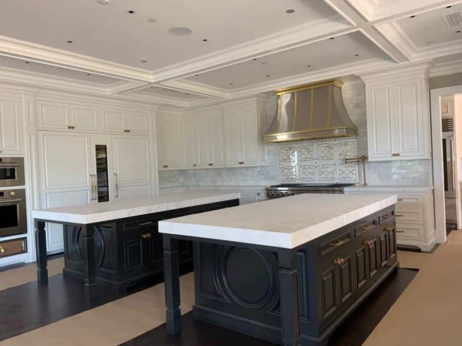 two tone white and black kitchen with two islands 