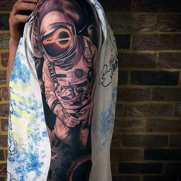 Psychedelic astronaut tattoo on the left inner forearm