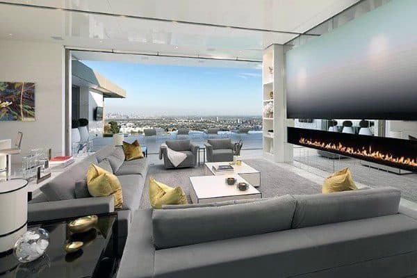 luxury living room with fireplace large screen tv and gray sofa