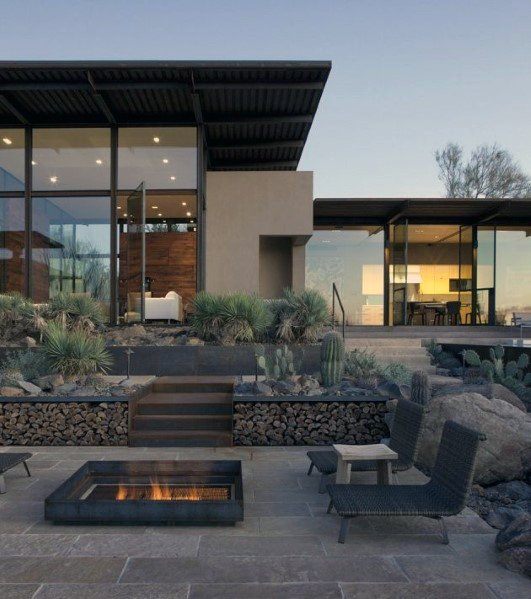 modern desert home with stone patio wicker lounges fire pit 