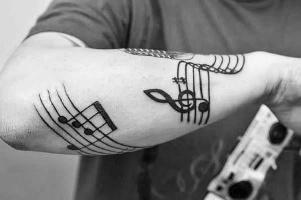 50 Amazing Music Staff Tattoo Designs for Men [2023 Guide]