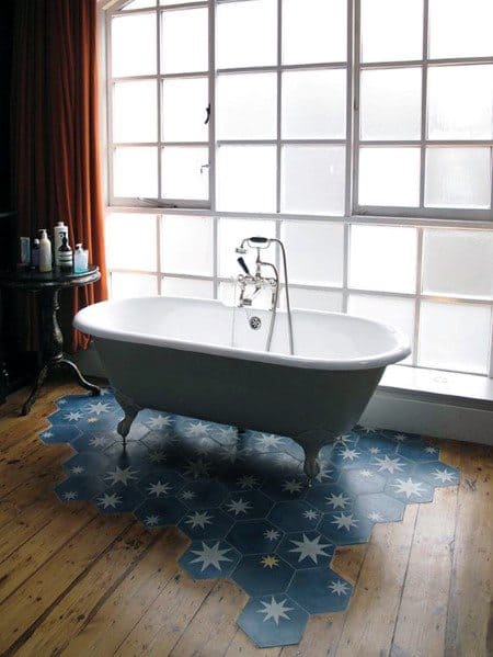 freestanding tub on blue tiles