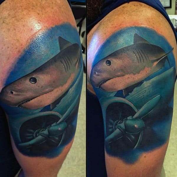 Upper Armman With Water Themed Tattoo Of Shark And Airplane