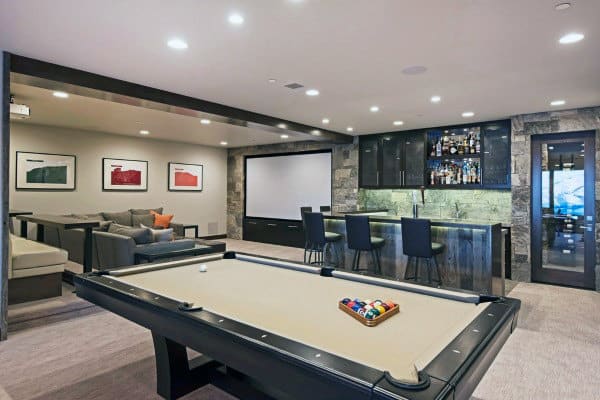 basement game room with billiards, arcade games, and home theatre