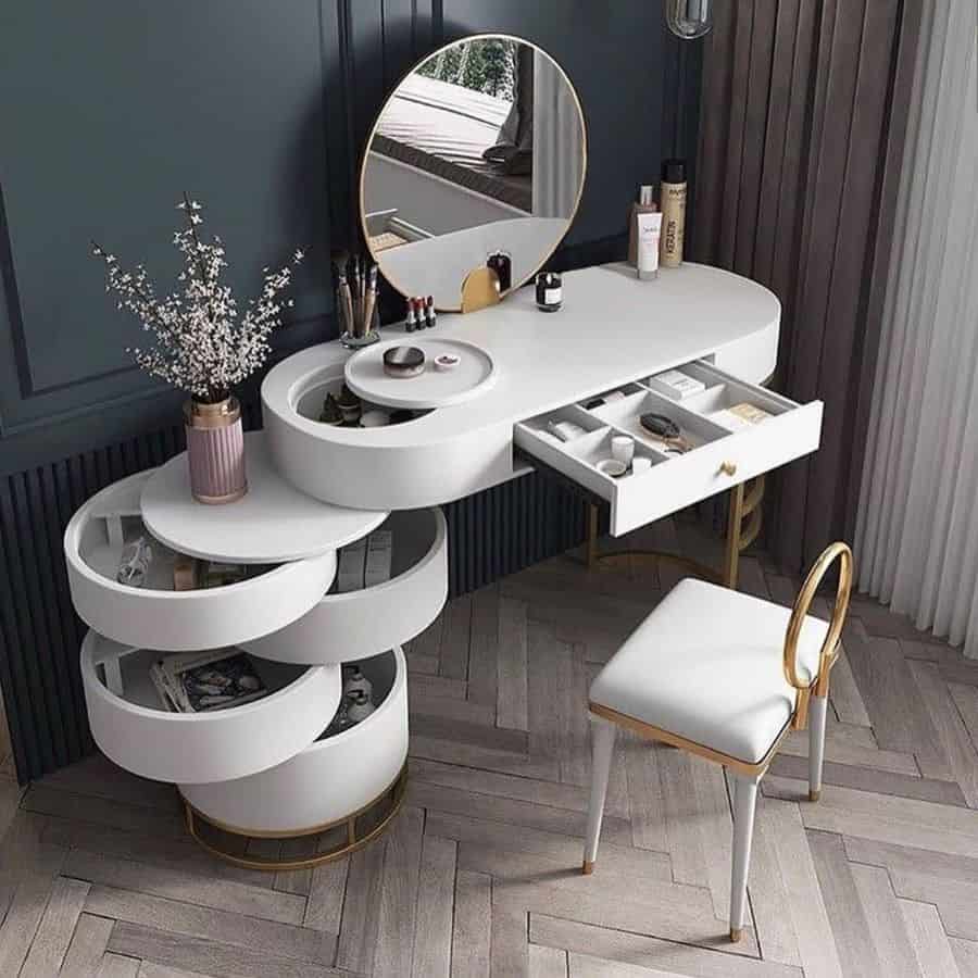 Modern white vanity with rotating storage shelves, drawer, and round mirror.