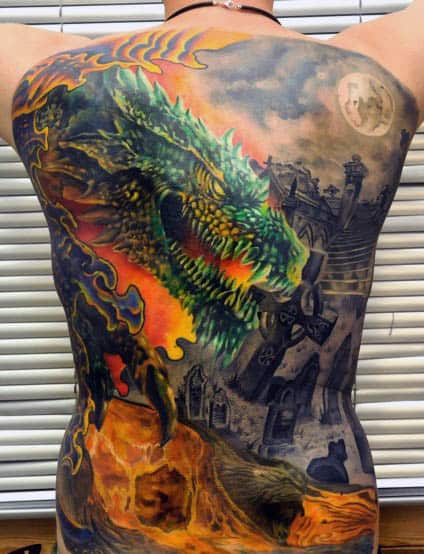 Vibrant Large Back Tattoo On Man Of Godzilla In The Night With Fire