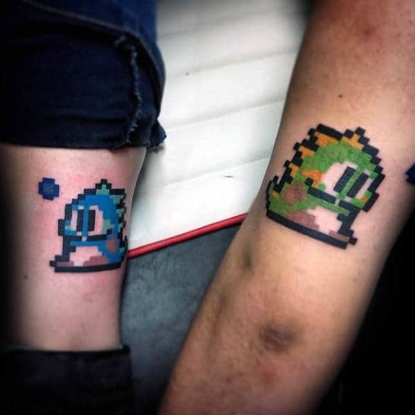 video game brother tattoos for guys on tricep and lower leg
