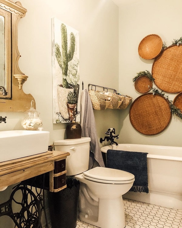 cactus painting above white toilet