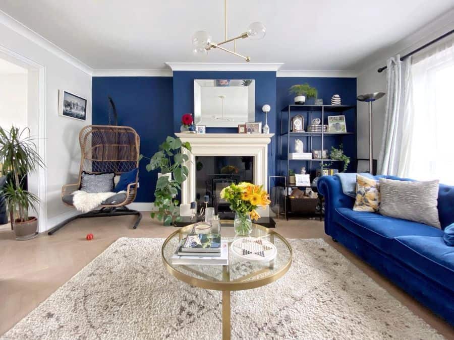 blue feature wall boho living room blue couch gold accents
