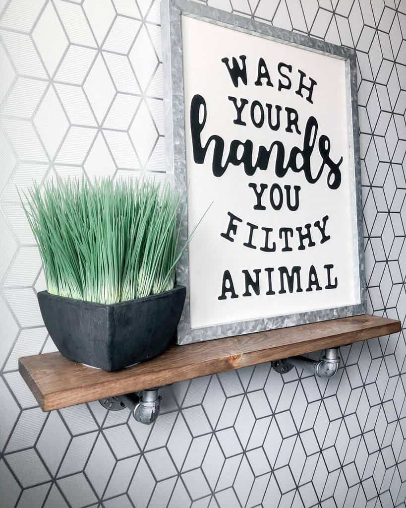 wood shelf on pattern tile wall with plant and slogan artwork