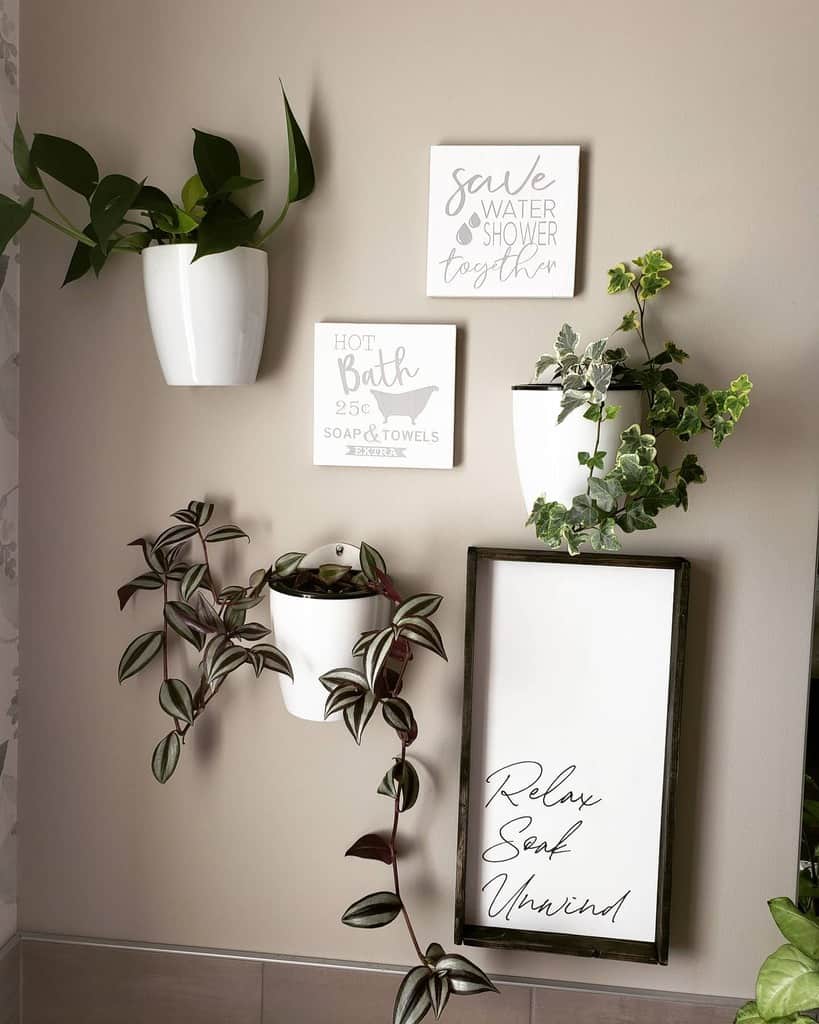 white hanging pot plants and wall art in bathroom 