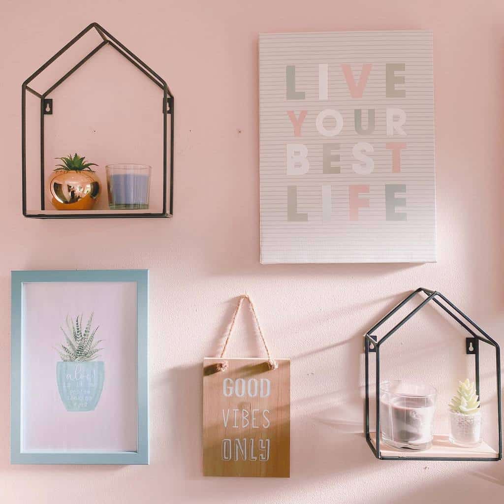 pink bathroom wall framed art and metal house shaped shelves 