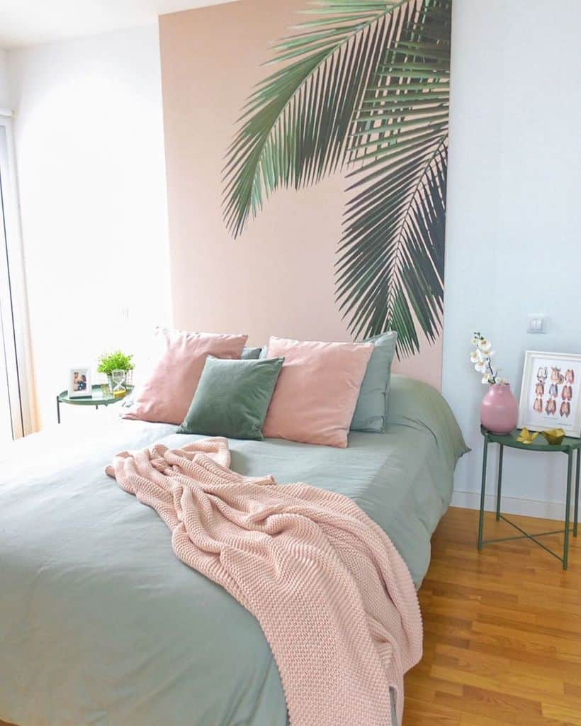 pink feature wall with palm leaf in pastel color bedroom 