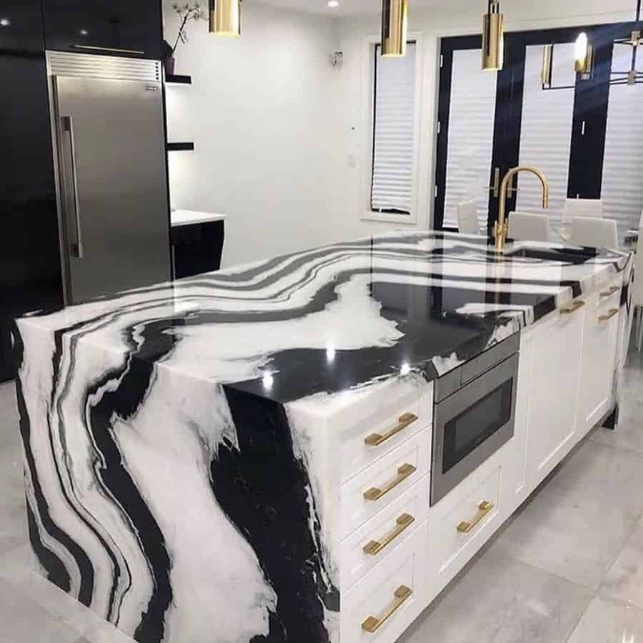 black and white marble countertop kitchen island with gold accents 