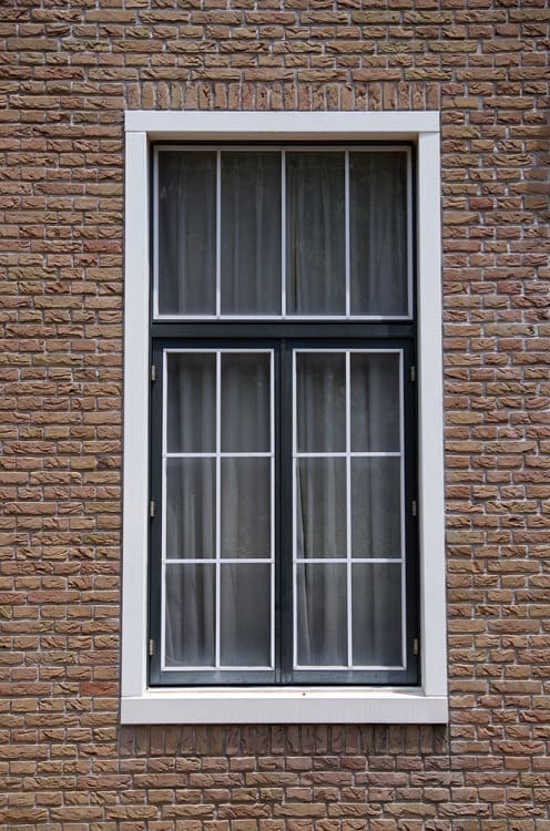 white and black exterior window trim for brick home