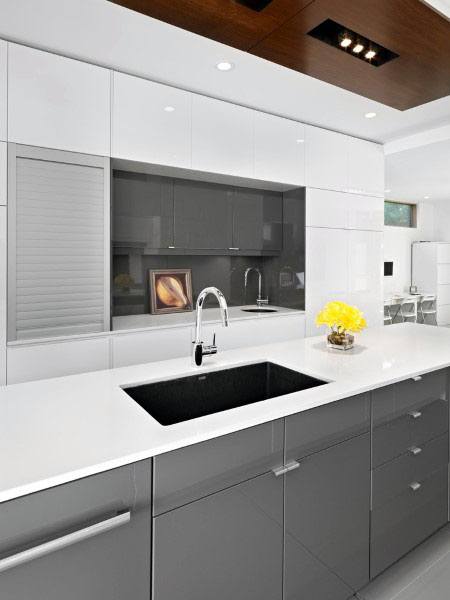 sleek white kitchen with gray cabinets 