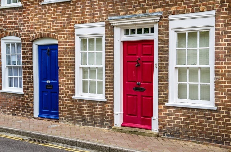 white exterior window trim brick homes blue and red doors