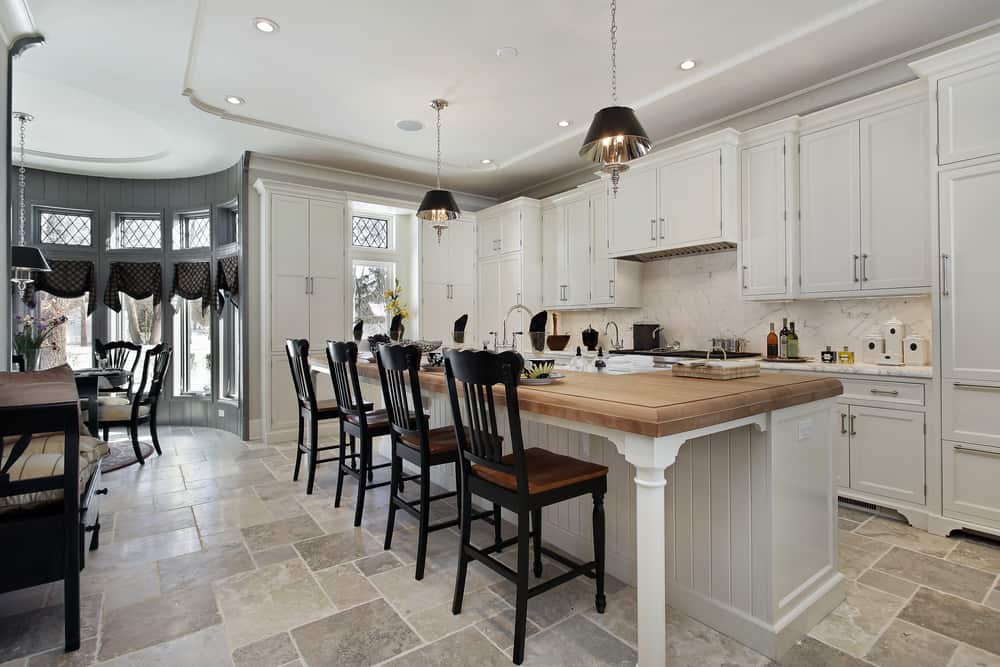 luxury farmhouse kitchen white cabinets black chairs wood island 