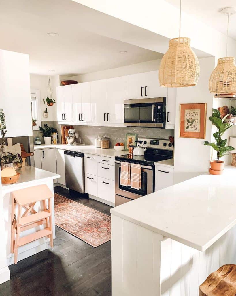 farmhouse kitchen white cabinets black accents pink ladder pot plants 