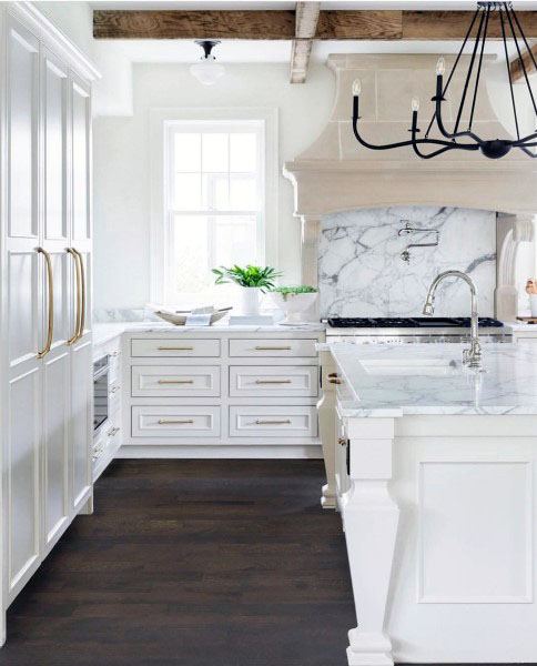 country style kitchen with white cabinets and gold accents 