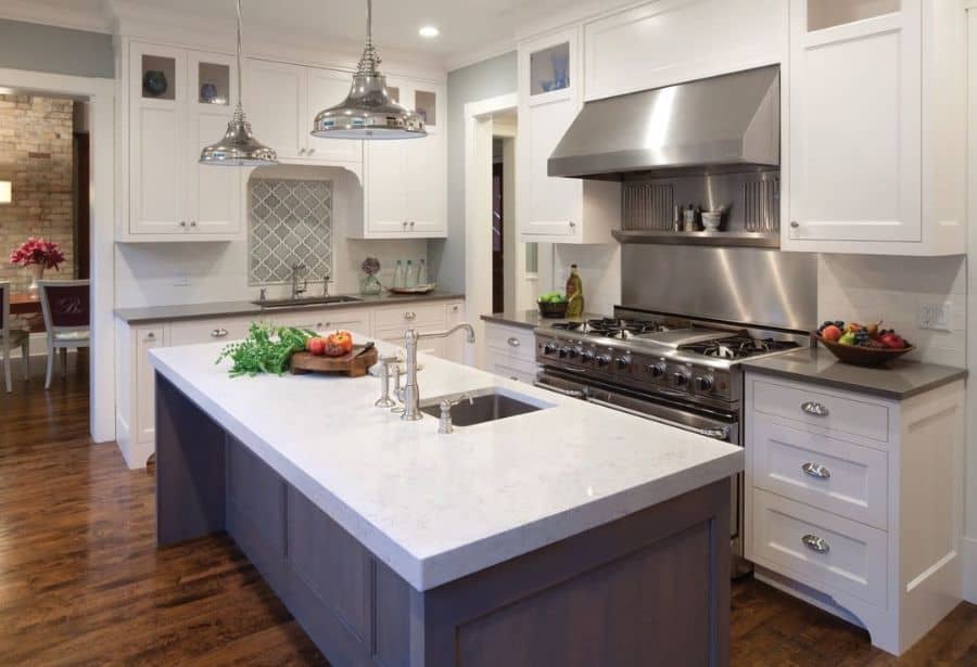 white kitchen cabinets and wood island with white countertop 